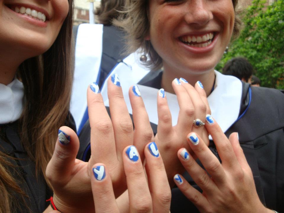 female students with manicure that reads Y.A.L.E.