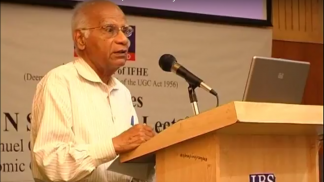 T.N. Srinivasan speaking at podium